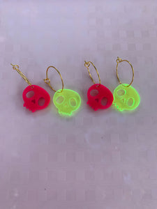 Fluorescent green skull earrings